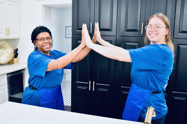 two women happily celebrating after work