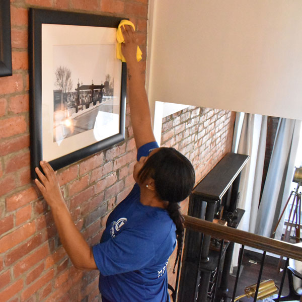 woman cleaning a wall