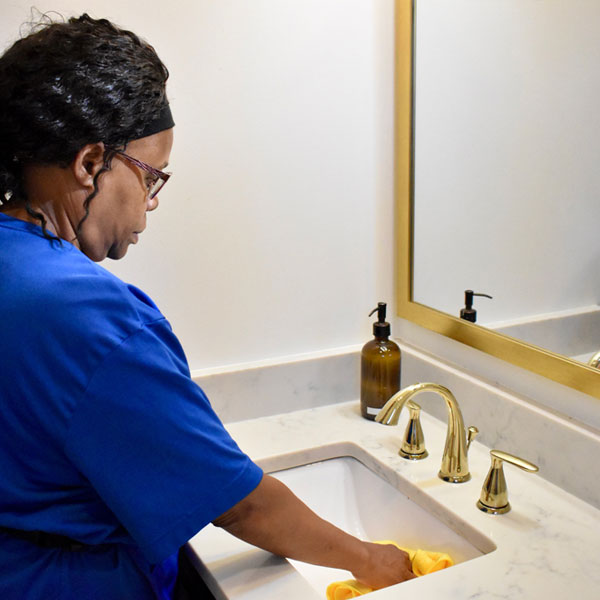 women cleaning a bathroom